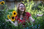 Jamie anointed with light. She is bathed with the sunflowers & mints in her urban garden. 
